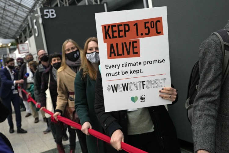 Climate activists hold a demonstration outside the venue of the COP26 U.N. Climate Summit in Glasgow, Scotland, on Friday.

