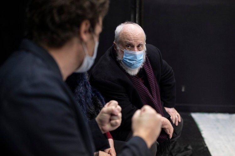 Playwright David Butler, right, talks with the play’s director, Nick Schroeder, during a break in the rehearsal of Butler’s play, “Dying to Know,” at Mad Horse Theatre Company.