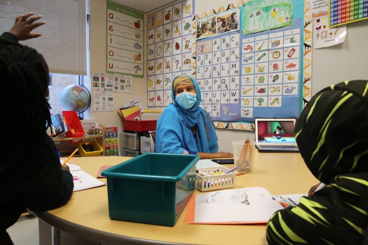 Kindergarten ELL teacher Hana Tallan teaches a small group of students at East End Community School. Tallan worked her way up from a language facilitator to an ed tech to a teacher and says she is happy to see Portland schools giving more support to educators of color. 