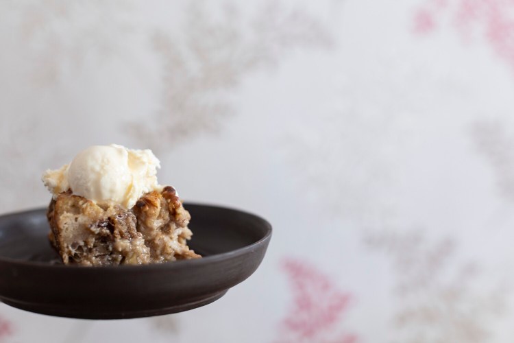 Christine Burns Rudalevige’s Maple-Walnut Bread Pudding topped with ice cream and more maple syrup.