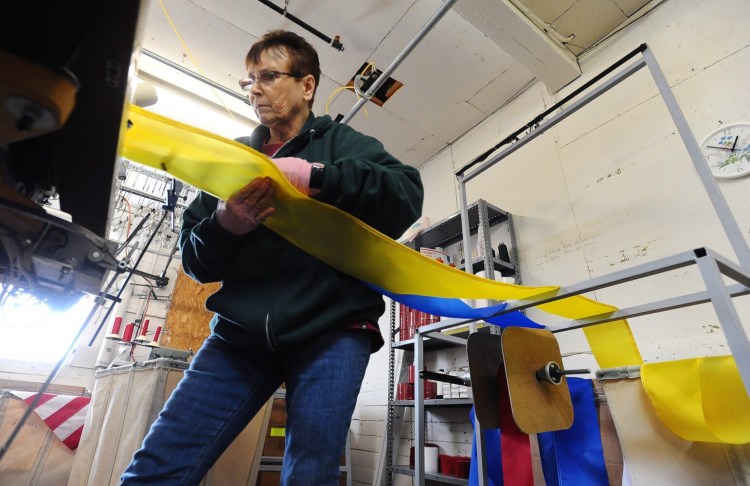 Charlene Goodridge begins the process of manufacturing a Ukrainian flag Monday at Maine Stitching Specialties in Skowhegan. 