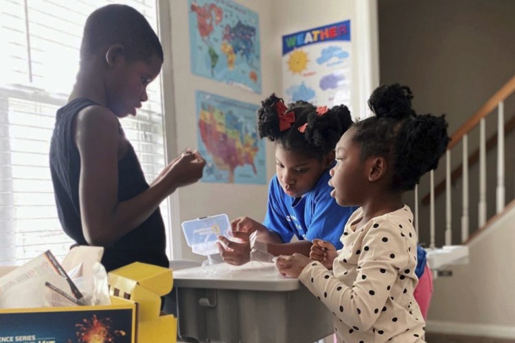 In an undated photo, Ahmad Waller, 11, Zion Waller, 10, and Drew Waller, 7, left to right, study during homeschooling, in Raleigh, N.C.