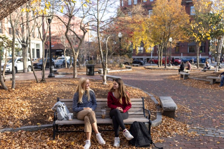Portland High seniors East Underwood, left, and Molly Snow sit together in Post Office Park during a break in their school day in November.