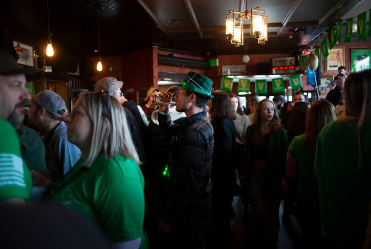 Paul Proulx of North Yarmouth finishes his beer at Rí Rá in Portland on St. Patrick's Day in 2022.